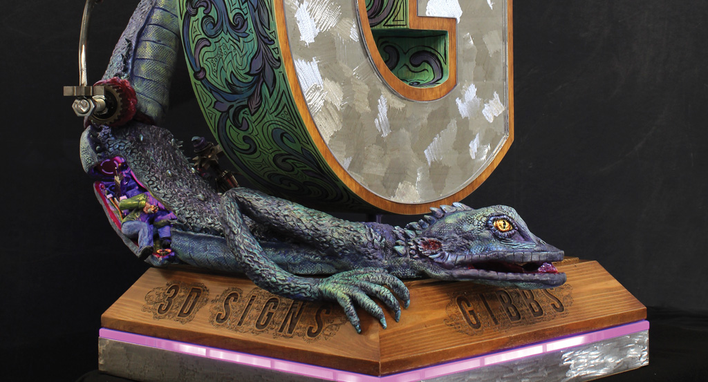 sculpture of lizard with a wood base and other elements